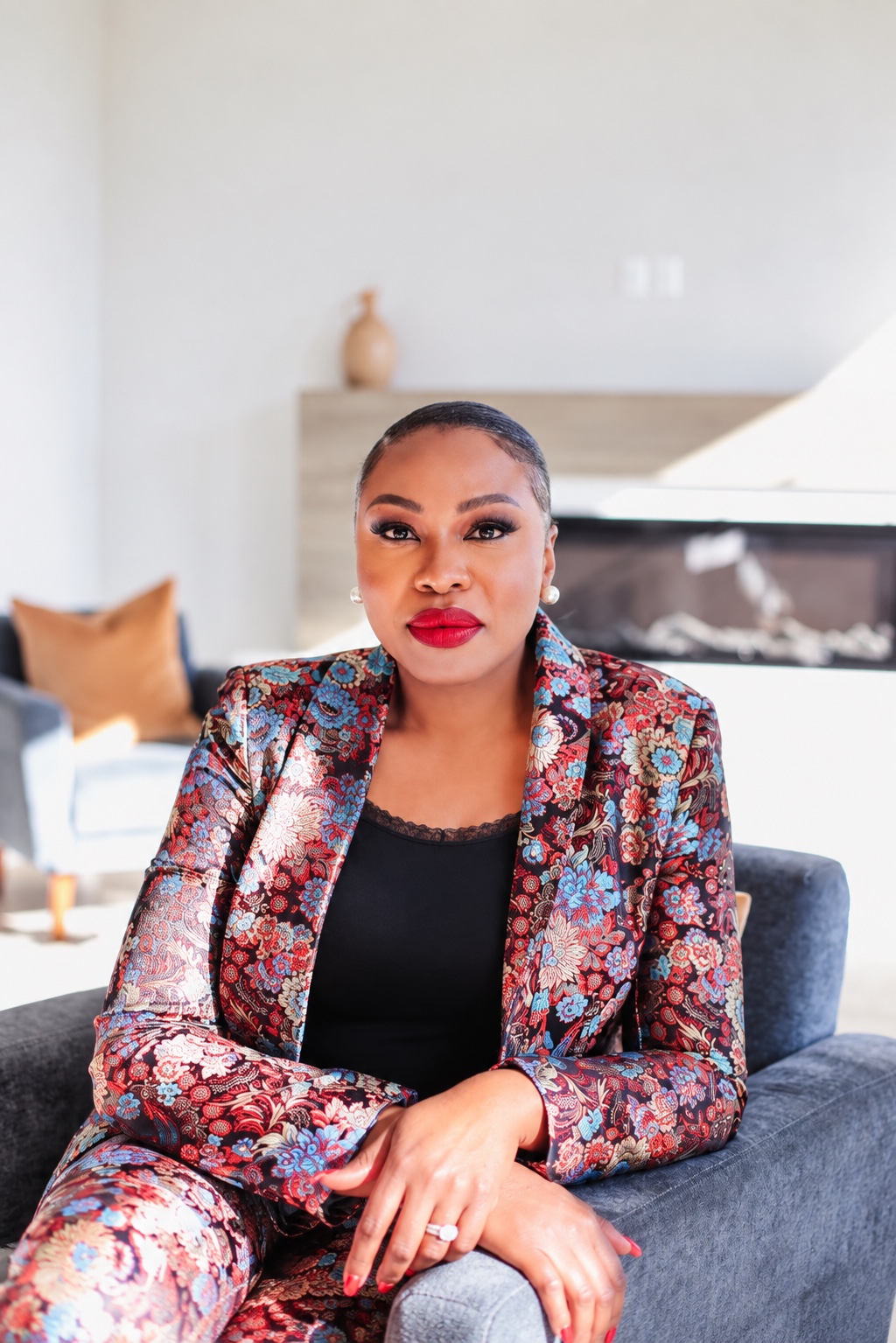 Pastor Valerie seated in a colourful floral blazer